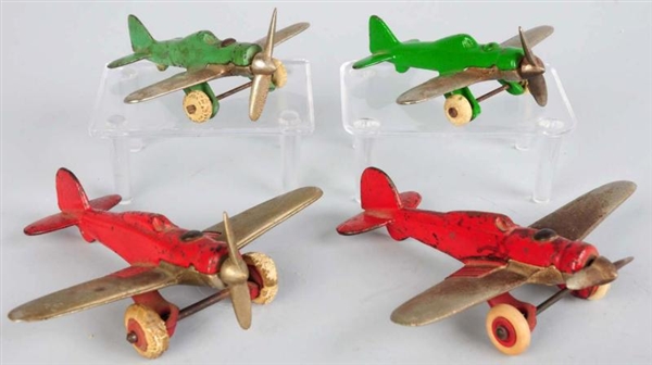 LOT OF 4: CAST IRON HUBLEY PURSUIT AIRPLANE TOYS. 
