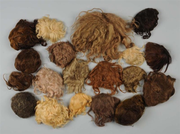 LOT OF 18 DOLL WIGS.                              