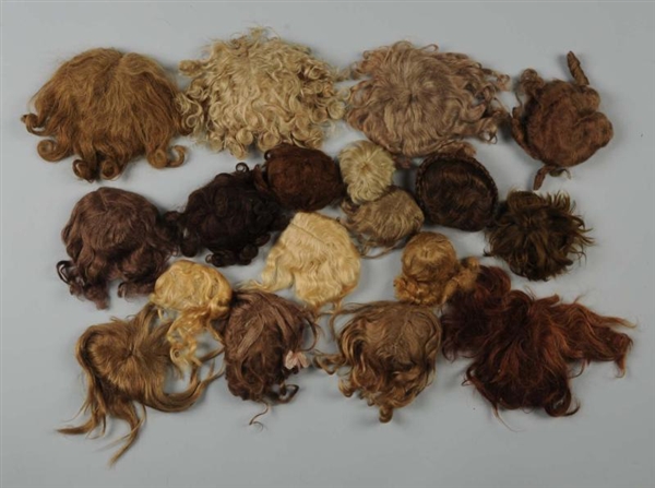 LOT OF 17 DOLL WIGS.                              