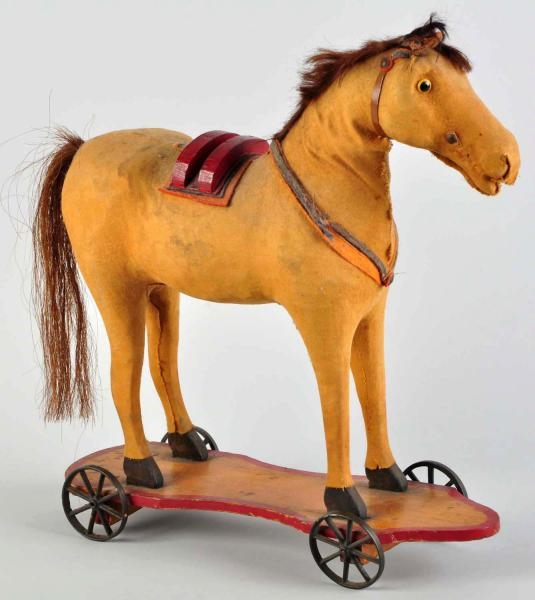 LARGE HIDE-COVERED HORSE PULL TOY.                
