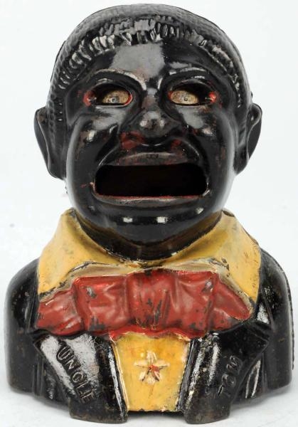 CAST IRON UNCLE TOM MECHANICAL BANK.              