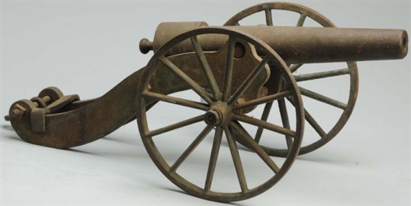 CAST IRON CANNON WITH METAL WHEELS.               