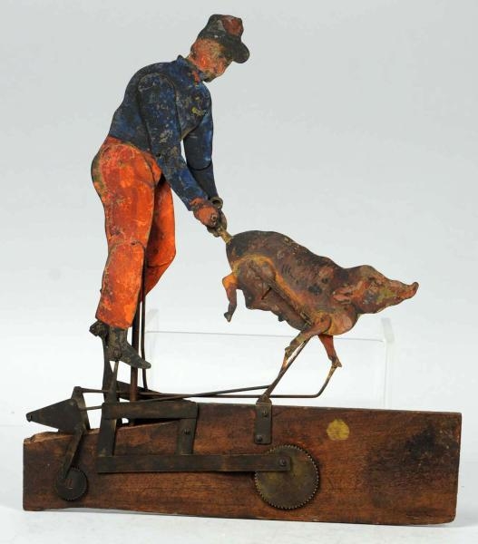 EARLY TIN & WOOD MAN WITH PIG WHIRLIGIG TOY.      