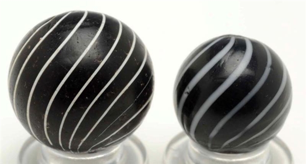 LOT OF 2: BLACK CLAMBROTH MARBLES.                