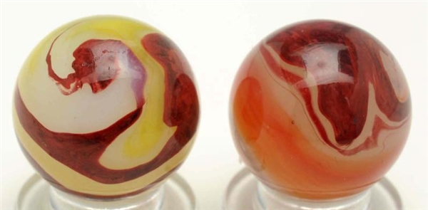 LOT OF 2: AKRO AGATE OXBLOOD MARBLES.             