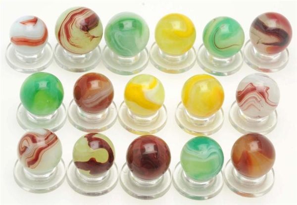 LOT OF 16: ASSORTED MACHINE MADE MARBLES.         