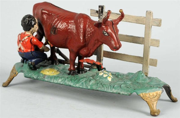 CAST IRON MILKING COW MECHANICAL BANK.            