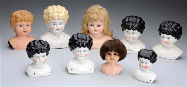LOT OF 9: DOLL HEADS.                             