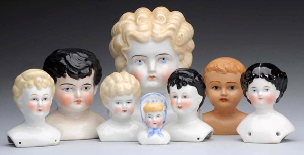 LOT OF 8: DOLL HEADS.                             