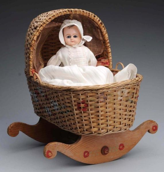 EARLY BABY WITH WICKER CRADLE.                    