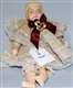 COMPOSITION DOLL WITH MAROON BOW.                 