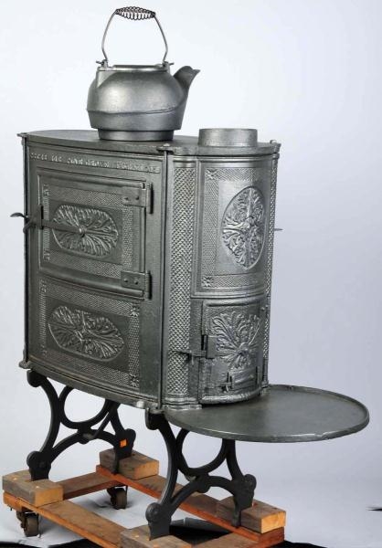 PINE GROVE CAST IRON STOVE WITH TEA KETTLE.       