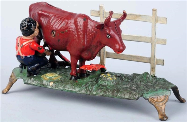 CAST IRON MILKING COW MECHANICAL BANK.            