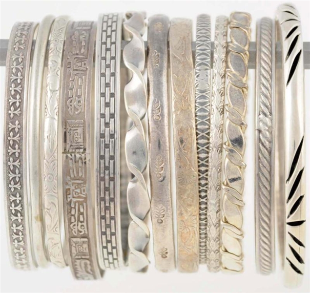 LOT OF 12: STERLING & MEXICAN SILVER BANGLES.     