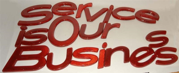 RED "SERVICE IS OUR BUSINESS" LETTERS.            