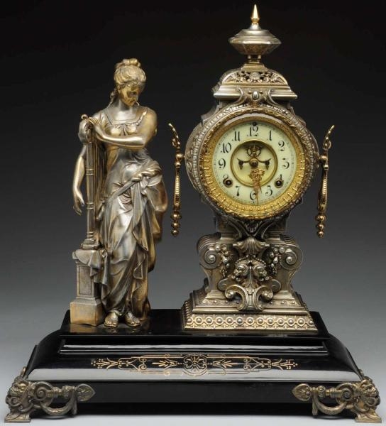 LARGE METAL CLOCK WITH LADY PLAYING HARP.         