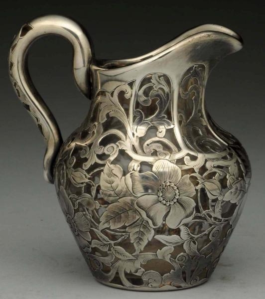 SILVER OVERLAY PITCHER.                           
