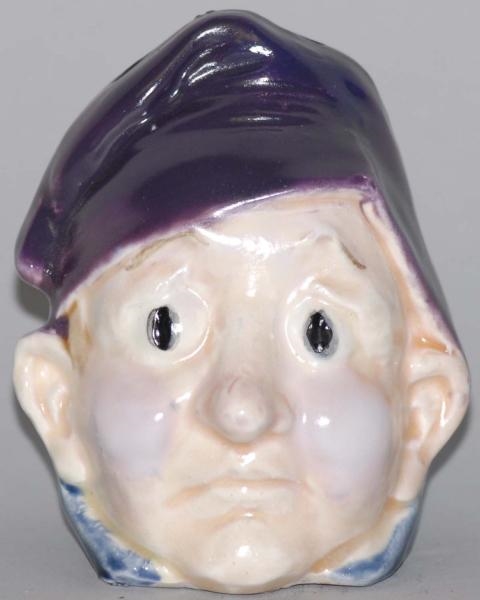 POTTERY FROWNING BOY WITH PURPLE HAT STILL BANK.  