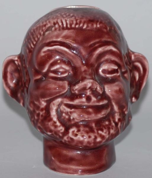 POTTERY MAROON UNCLE TOM STILL BANK.              