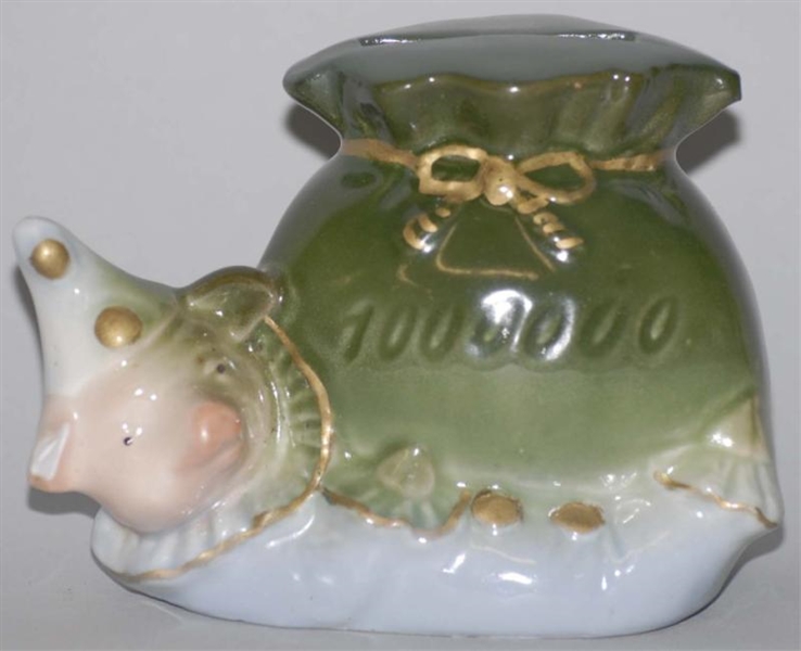 POTTERY PIG WITH MONEY BAG STILL BANK.            