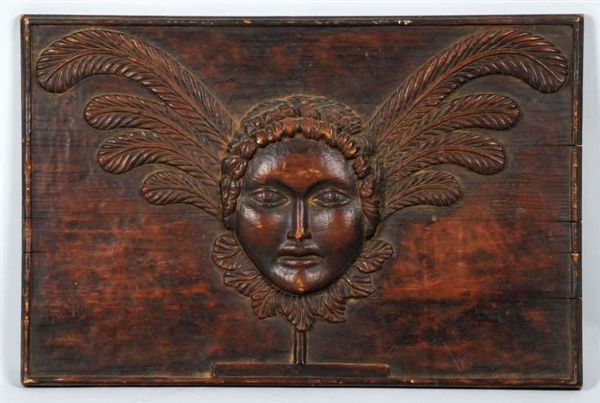 ORNATE WOOD-CARVED PLAQUE WITH WOMANS HEAD.      