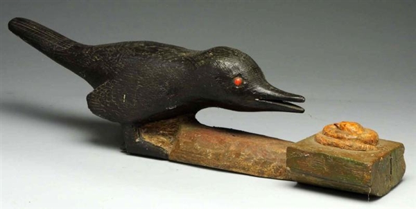 WOODEN CARVED BIRD ATTACKING SNAKE.               
