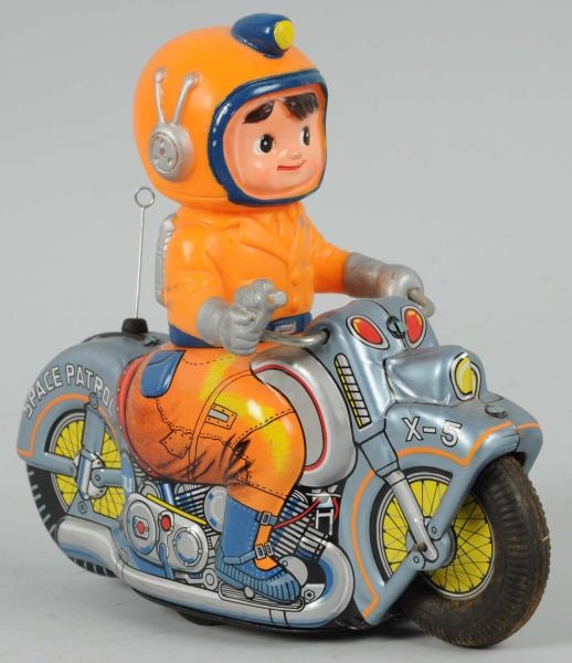 TIN LITHO SPACE PATROL ASTRONAUT ON MOTORCYCLE.   