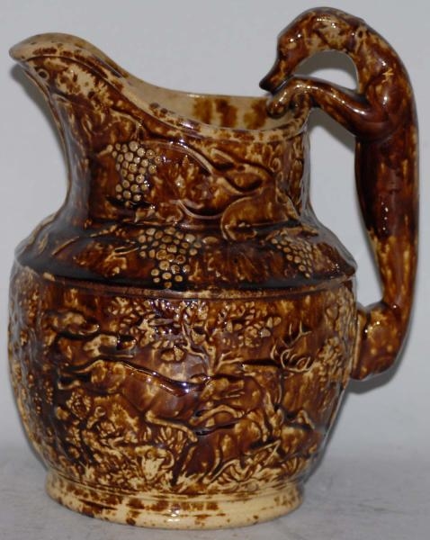 POTTERY PITCHER WITH DOG HANDLE.                  