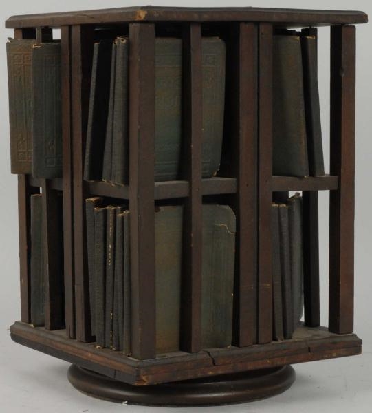 SMALL WOODEN ROTATING BOOK RACK.                  