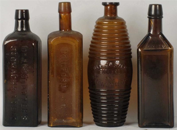 LOT OF 4: ASSORTED DARK GLASS BOTTLES.            