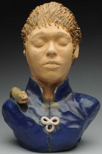 CERAMIC BUST OF BOY WITH SNAKE.                   