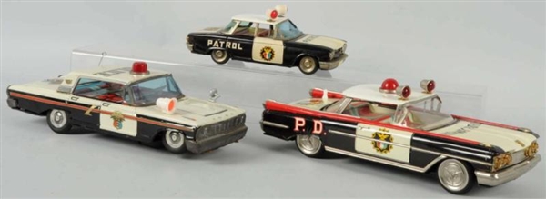 LOT OF 3: TIN FRICTION POLICE CAR TOYS.           