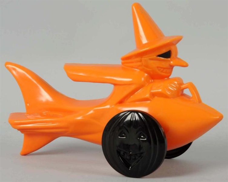 PLASTIC ORANGE WITCH ON ROCKET CANDY CONTAINER.   