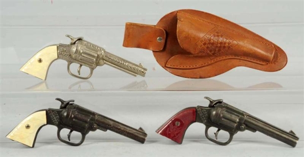 LOT OF 3: CAST IRON CAP GUNS & TOM MIX HOLSTER.   
