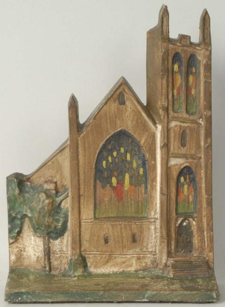 CAST IRON CHURCH WITH STAINED GLASS DOORSTOP.     
