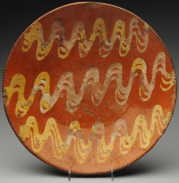 LARGE 19TH CENTURY REDWARE CHARGER.               