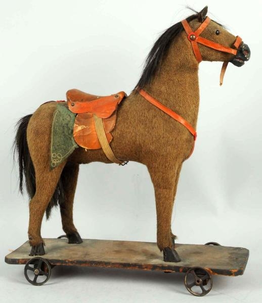LARGE HIDE-COVERED HORSE ON PLATFORM TOY.         