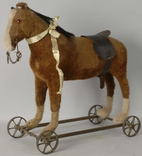 STRAW-FILLED & FUR-COVERED HORSE ON METAL WHEELS. 