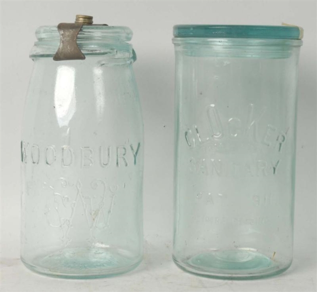 LOT OF 2: GLASS JARS WITH LIDS.                   