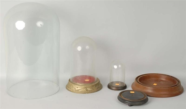 LOT OF 3: GLASS DOMES WITH WOODEN BASES.          