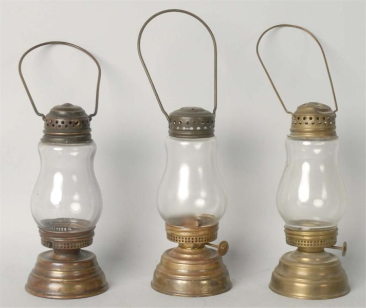 LOT OF 3: CLEAR GLASS BRASS SKATERS LANTERNS.    