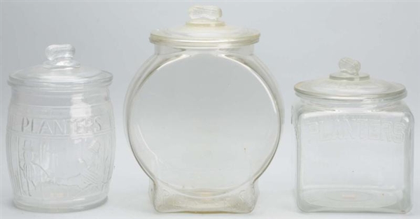 LOT OF 3: GLASS PLANTERS PEANUT JARS WITH LIDS.   