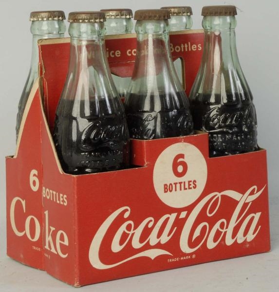 1950S COCA-COLA CARRIER WITH FILLED BOTTLES.      