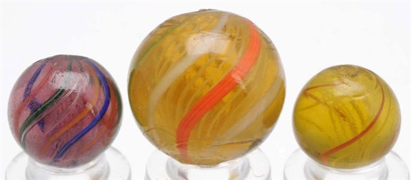LOT OF 3: COLORED GLASS SWIRL MARBLES.            