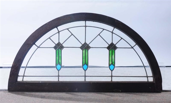 ANTIQUE ARCHED STAINED GLASS WINDOW.              