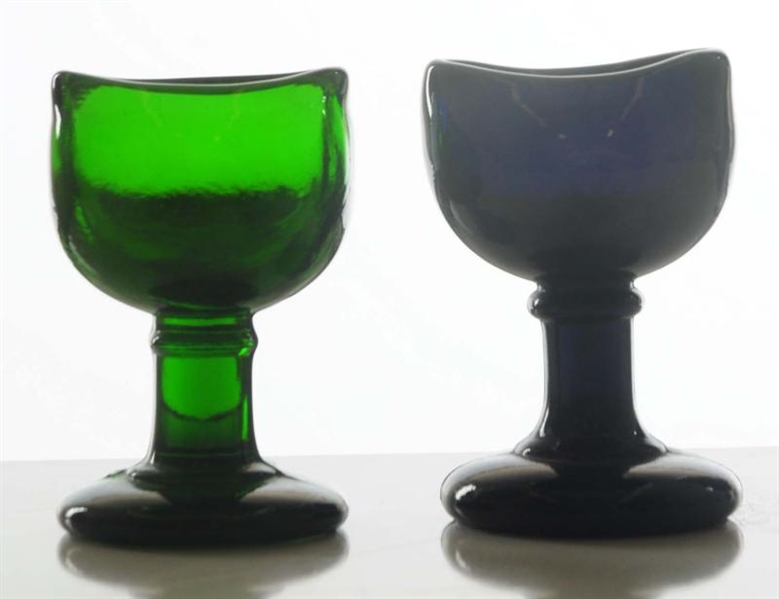 LOT OF 2: COLORED GLASS EYE CUPS.                 