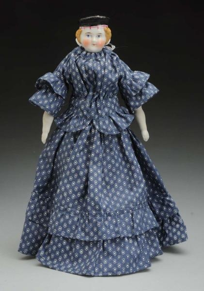 GERMAN CHINA DOLL WITH MOLDED HAT.                