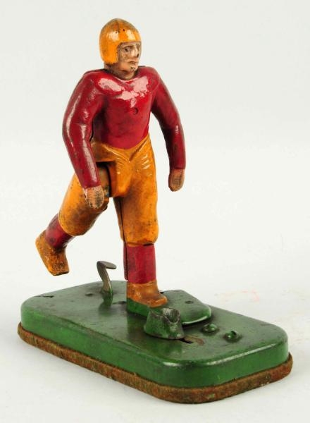 CAST IRON  MECHANICAL FOOTBALL PLAYER TOY.        
