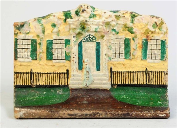 CAST IRON COTTAGE WITH WOMEN ON STEPS DOORSTOP.   
