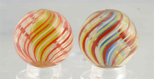 LOT OF 2: CAGED SOLID CORE SWIRL MARBLES.         